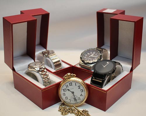 4 watches in their own red boxes and a gold pocket watch