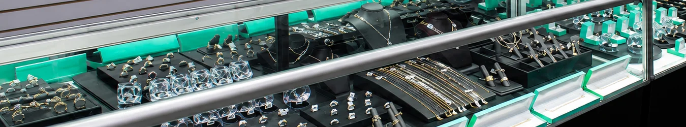 A pile of gold rings with diamons and other stones